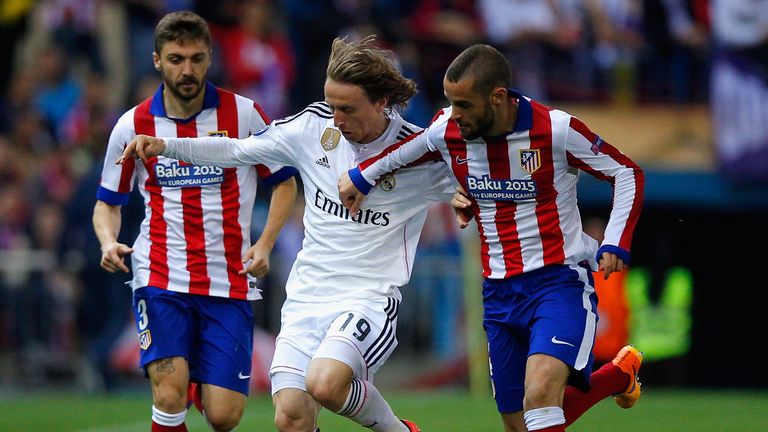 MADRID, SPAIN - APRIL 14: Luka Modric of Real Madrid CF is closed down by Guilherme Siqueira and Mario Suarez of Atletico Madrid (R) during the UEFA Champi