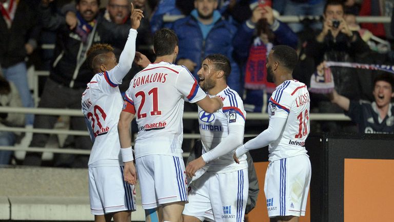 Lyon's Cameroonian forward Clinton Njie (left) is congratulated by team-mates after scoring a goal v St Etienne in Ligue 1