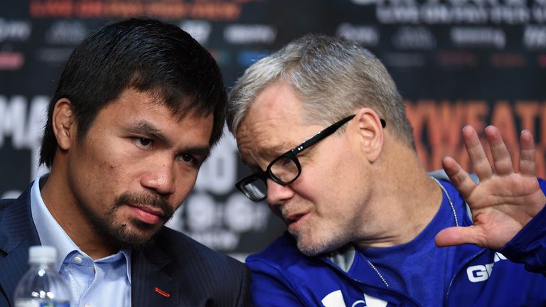 WBO welterweight champion Manny Pacquiao talks with his trainer Freddie Roach 