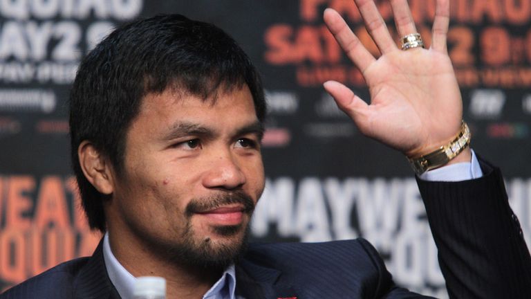 WBO welterweight champion Manny Pacquiao waves during a  news conference