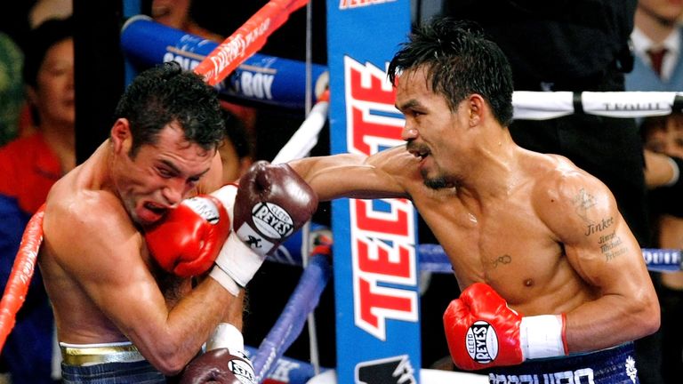 Manny Pacquiao (R) of the Philippines connects with a right to the head of Oscar De La Hoya during their welterweight fight in 2008