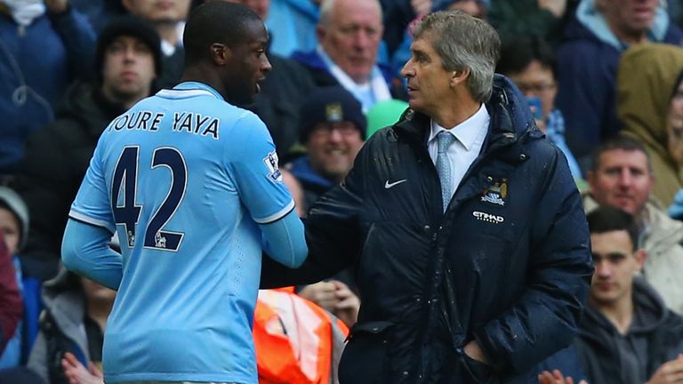 Manchester City manager Manuel Pellegrini chats to his midfielder Yaya Toure who could be heading for the exit door this summer