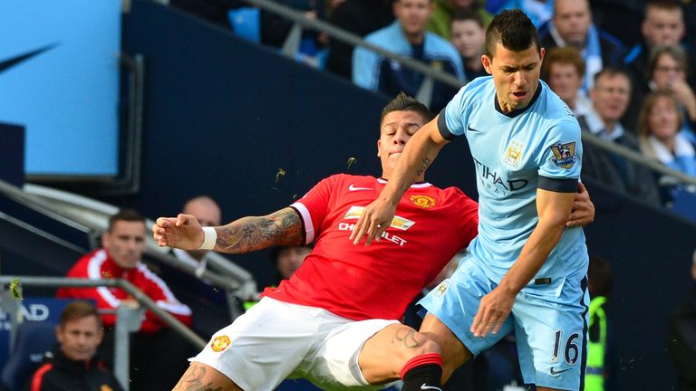 Manchester United defender Marcos Rojo battles with Manchester City striker Sergio Aguero during the Premier League match in November 2014