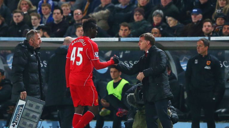 Mario Balotelli of Liverpool shakes hands with Brendan Rodgers manager of Liverpool as he is substituted during the Barclays Pre