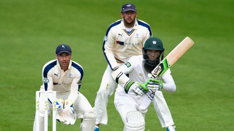 WORCESTER, ENGLAND - APRIL 12:  Worcestershire batsman Moeen Ali picks up some runs watched by Yorkshire keeper Andy Hodd looks on during day one of the LV