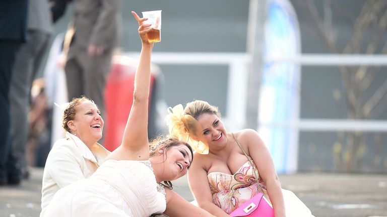 Racegoers after final race of Ladies Day of the Crabbies Grand National Festival