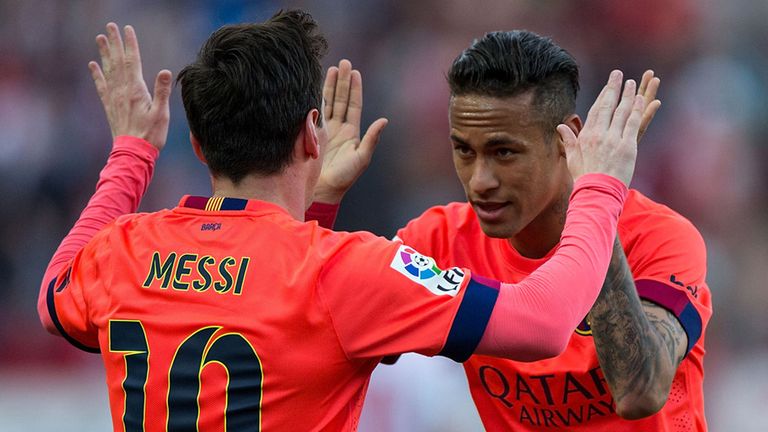 Lionel Messi (left) of Barcelona celebrates scoring their opening goal with teammate Neymar