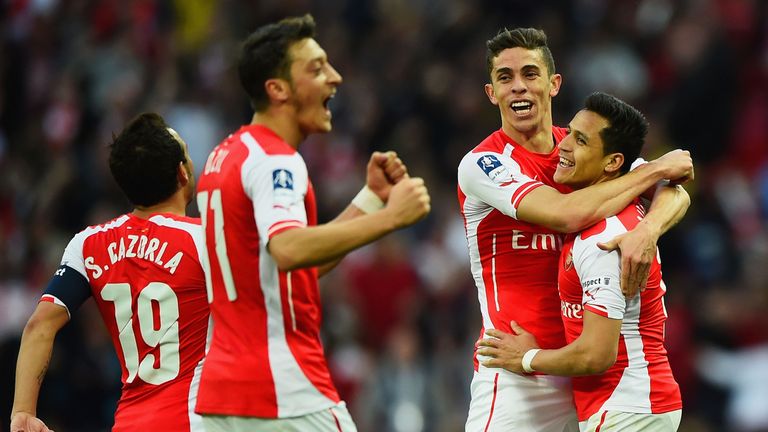 Alexis Sanchez of Arsenal (R) celebrates with Santi Cazorla (L), Mesut Oezil (2L) and Gabriel (2R) as he scores their second g