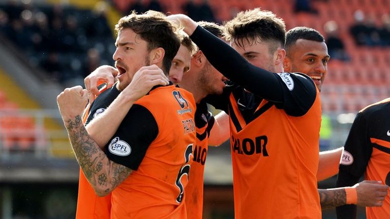 Chris Erskine is mobbed by his Dundee United team mates after scoring the winner against Hamilton.