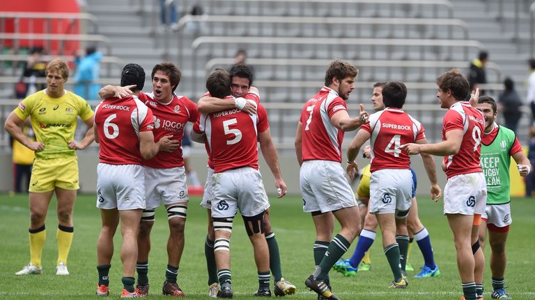 Portugal's players (red shirts) celebrate during their match against Australia at the Tokyo Rugby Sevens. Portugal defeated Australia 12-10.