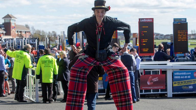 An entertainer on stilts before the 2015 Coral Scottish Grand National Festival at Ayr Racecourse.