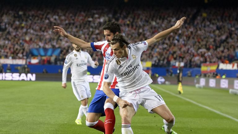 Raul Garcia vies with Gareth Bale