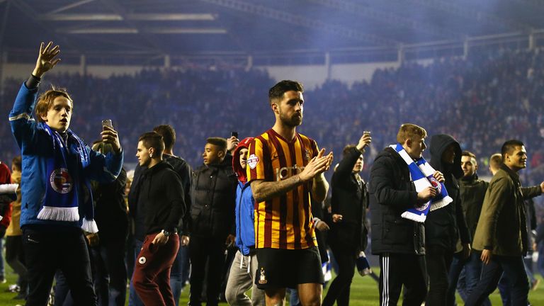 READING, ENGLAND - MARCH 16: Alan Sheehan of Bradford City leaves the field as Reading fans celebrate after the FA Cup Quarter Final Replay match between R