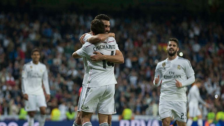 Alvaro Arbeloa (L) of Real Madrid CF celebrates scoring their third goal with teammate Javier Hernandez Chicharito