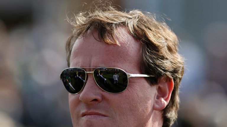 Richard Hannon sports a natty pair of Ray-Bans on another warm day at Newmarket.