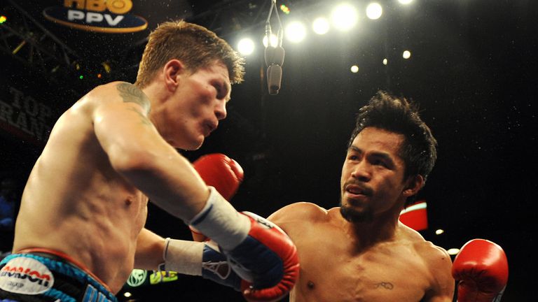 Manny Pacquiao (R) of the Philippines connects a punch on Ricky Hatton of England during their Junior Welterweight title fight at the MGM Grand Garden Aren