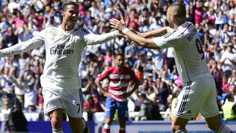 Cristiano Ronaldo (L) celebrates a goal with Real Madrid's French forward Karim Benzema