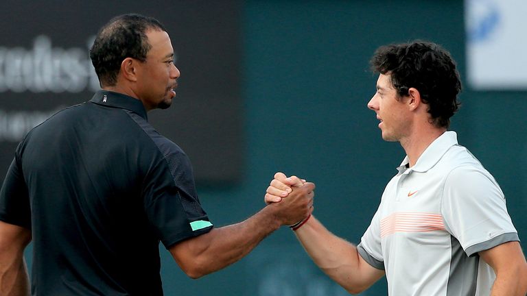 DUBAI, UNITED ARAB EMIRATES - JANUARY 31:  Rory McIlroy of Northern Ireland and Tiger Woods of the USA shake hands on the 18th greenduring the second round