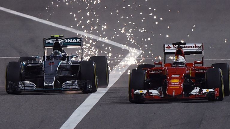Sparks fly as Nico Rosberg overtakes Sebastian Vettel during the Bahrain GP.