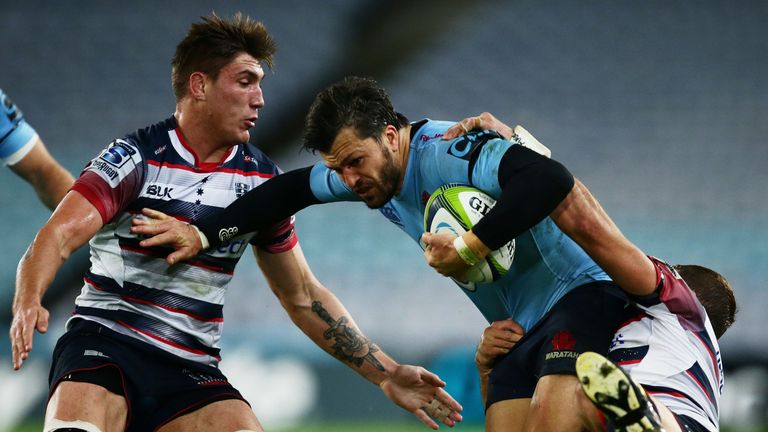 Adam Ashley-Cooper of the Waratahs is tackled v the Rebels