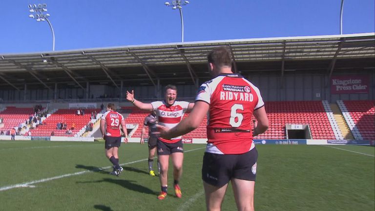 The Leigh players celebrate after their Challenge Cup victory over Salford