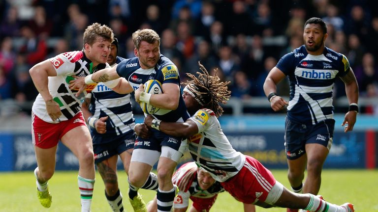 Mark Cueto of Sale Sharks is tackled by Harry Sloan and Marland Yarde of Harlequins