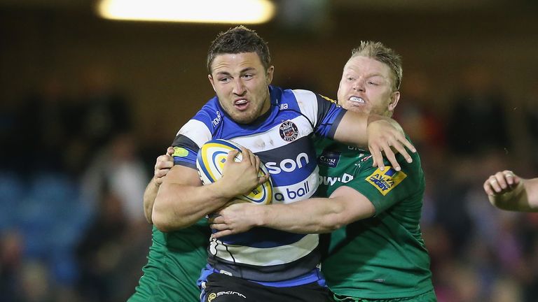 Sam Burgess of Bath is tackled by Alex Lewington (L) and Tom Court of London Irish