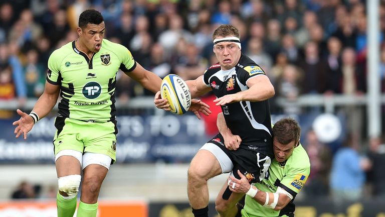 Sam Hill of Exeter Chiefs is tackled by Stephen Myler of Northampton Saints