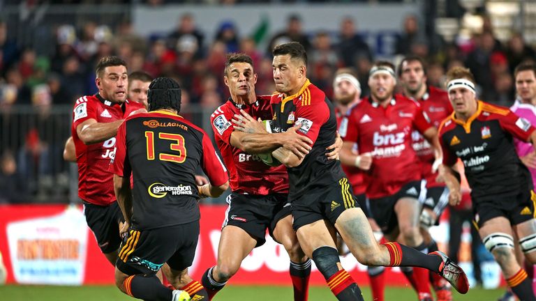 Sonny Bill Williams of the Chiefs is tackled by Dan Carter of the Crusaders
