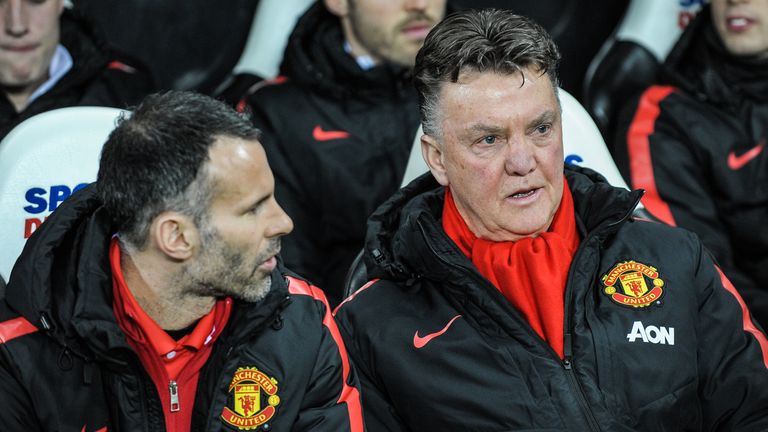 Manchester United manager Louis Van Gaal (R) sits in the dugout with assistant manager Ryan Giggs (L)