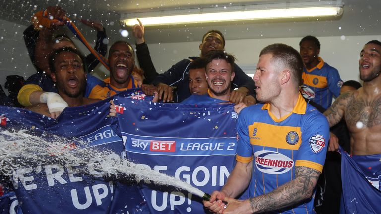 James Collins celebrates in the dressing room as Shrewsbury Town celebrate promotion to Sky Bet Football League One