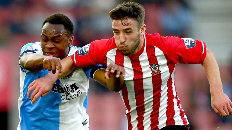 Sam McQueen of Southampton and Ryan Nyambe of Blackburn and challenge for possession