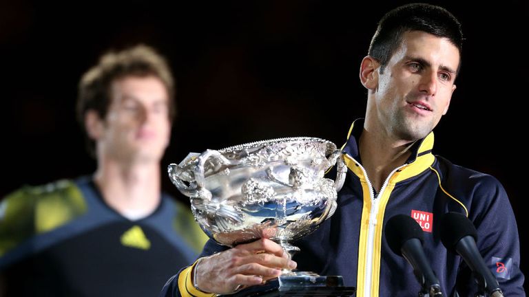 Andy Murray watches Novak Djokovic hold the Norman Brookes Challenge Cup at the 2013 Australian Open 