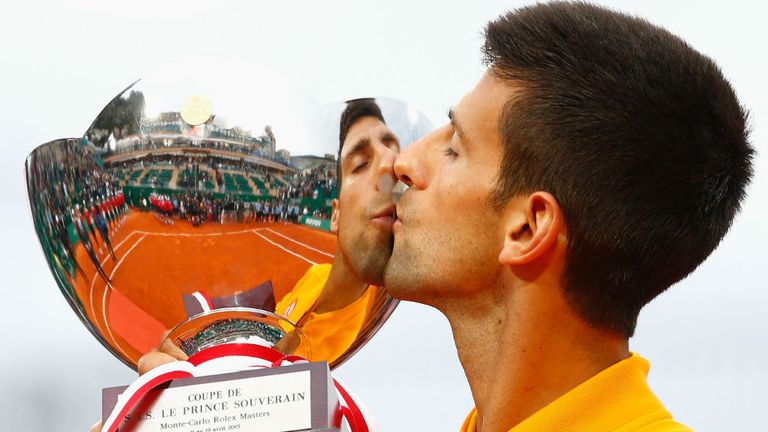 Novak Djokovic celebrates with the winners trophy after defeating Tomas Berdych in the Monte Carlo Masters final