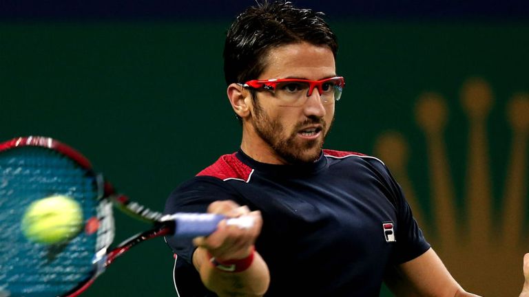 Janko Tipsarevic returns a ball to Marcel Granollers at the Shanghai Rolex Masters