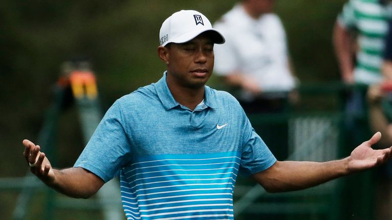 Tiger Woods gestures after teeing off on the fifth hole during a practice round for the Masters golf tournament Monday, April 6, 2015, in Augusta, Ga.