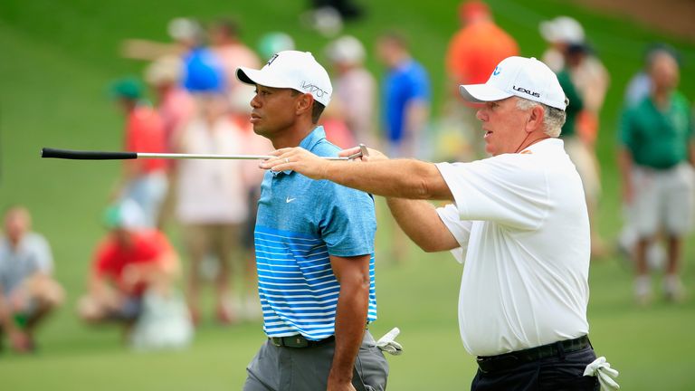 Tiger Woods talks with Mark O'Meara during his practice round 
