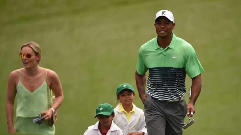 Tiger Woods (R) walks the fairway with Lindsey Vonn (L)