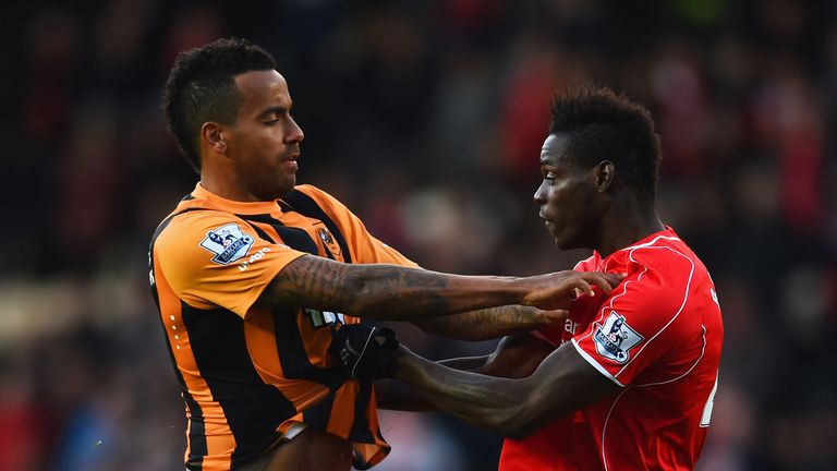 Tom Huddlestone of Hull City and Mario Balotelli of Liverpool clash