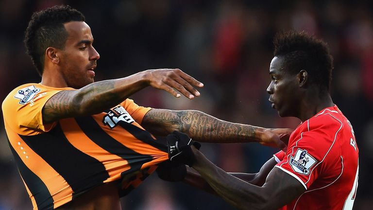 HULL, ENGLAND - APRIL 28:  Tom Huddlestone of Hull City and Mario Balotelli of Liverpool clash during the Barclays Premier League match between Hull City a