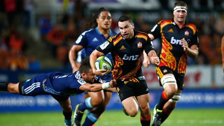 Tom Marshall of the Chiefs breaks the tackle of Jamison Gibson-Park of the Blues