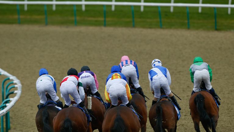 Runners and riders round the first bend during The Coral Easter Classic All-Weather Middle Distance Championships