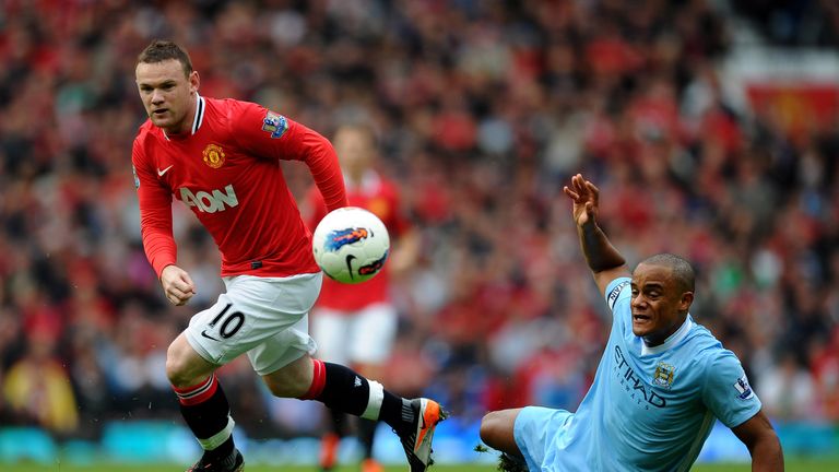 Wayne Rooney of Manchester United competes with Vincent Kompany of Manchester City during the Barclays Premier League match in October 2011