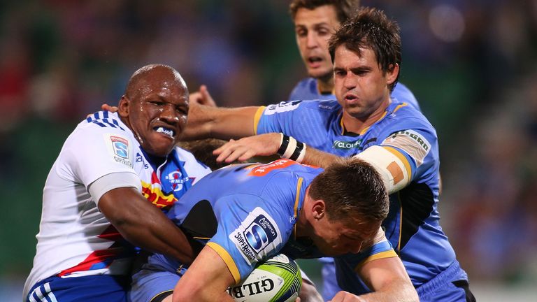 Dane Haylett-Petty of the Force gets tackled by Mbongeni Mbonambi of the Stormers