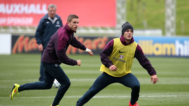 Jordan Henderson (L) and Jack Wilshere in action during a training session at St Georges Park on May 27, 2014 in Burt
