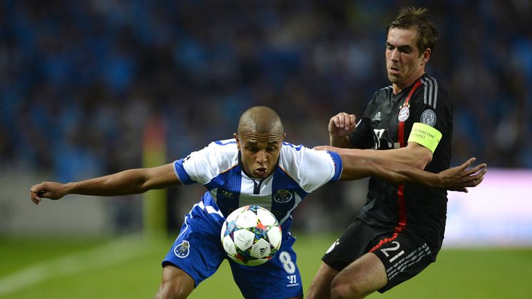 Yacine Brahimi keeps the ball away from Philipp Lahm 