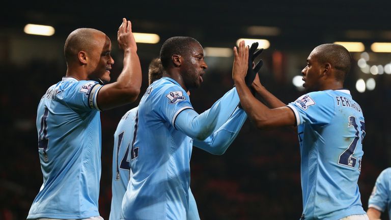 Yaya Toure of Manchester City celebrates scoring the third goal with his Fernandinho and Vincent Kompany during the 3-0 win over Manchester United in 2014