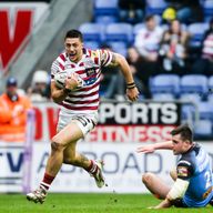 Wigan's Anthony Gelling makes a break from St Helens' Joe Greenwood.