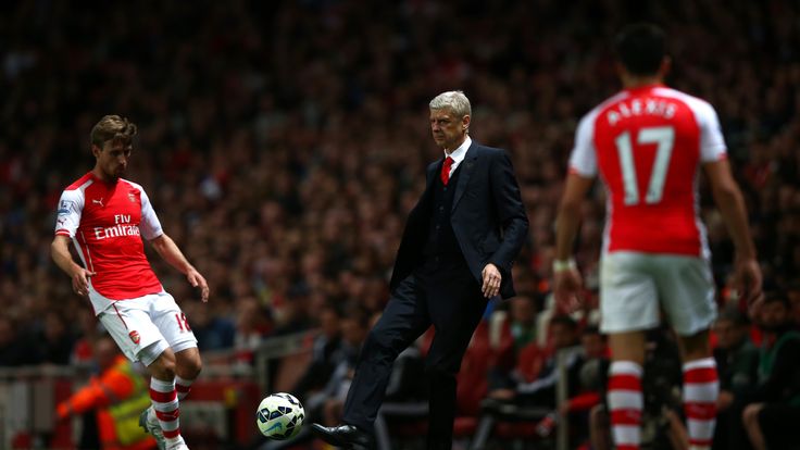 Arsene Wenger, manager of Arsenal plays the ball back onto the field during the Premier League match against Swansea