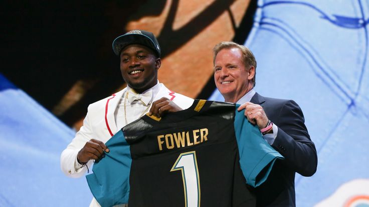 Dante Fowler Jr. of the Florida Gators holds up a jersey with NFL Commissioner Roger Goodell after being chosen #3 overall by the Jacksonville Jaguars 